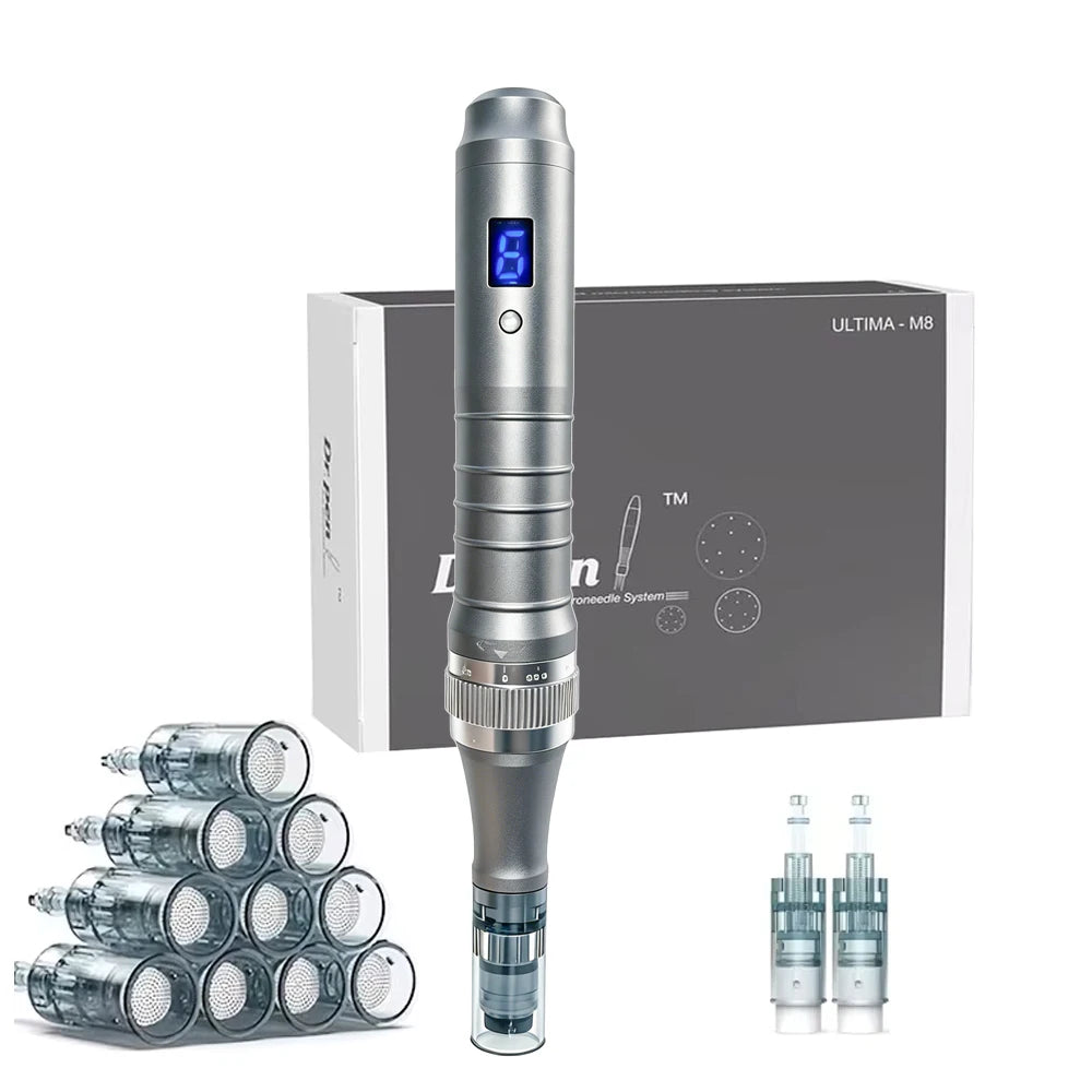 A silver electronic tattoo pen machine with a digital display, shown alongside its gray and white retail box, multiple needle cartridges stacked on the left, and two spare cartridges on the right, all on a white background.